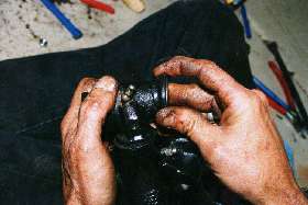 Putting rubber boots on the upper trunion