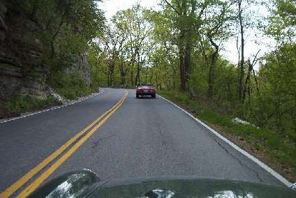 People under the nose of an MGB