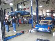 MGs in service shop with lifts